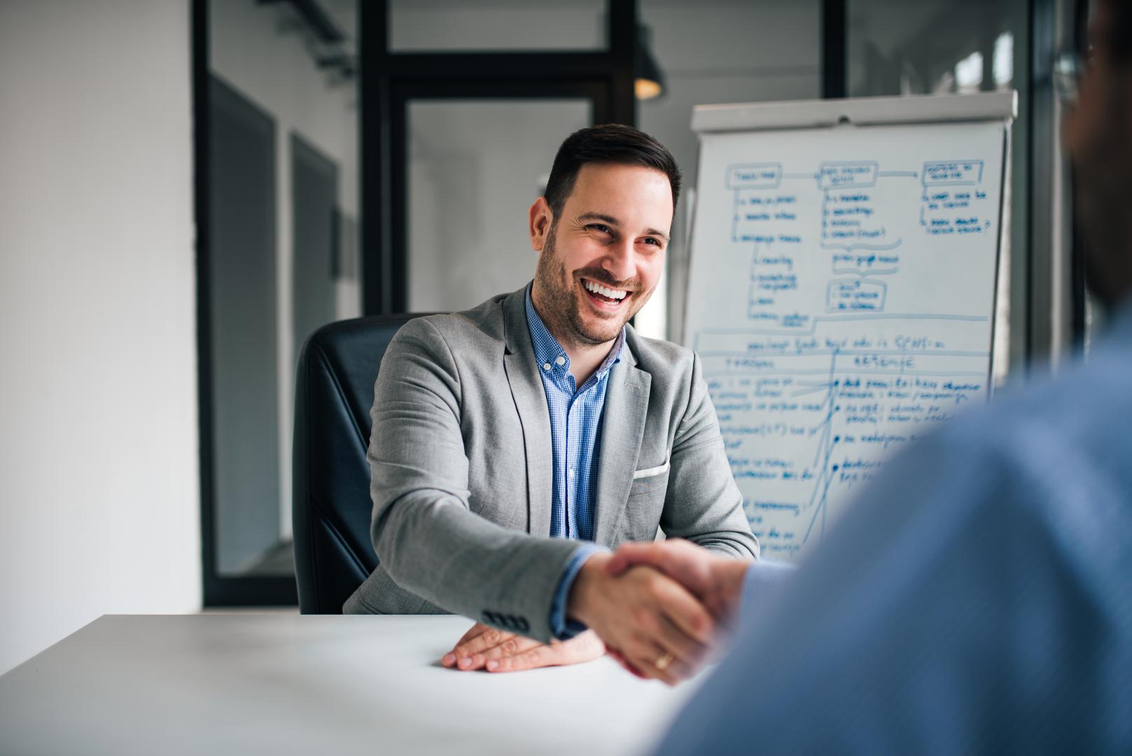 good-deal-two-business-people-shaking-hands-while-sitting-working-place
